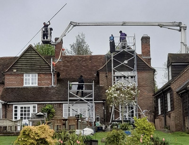 The Roof Moss Cleaners using cherry picker and scaffolding to clean roof safely and professionally in Thatcham, Berkshire